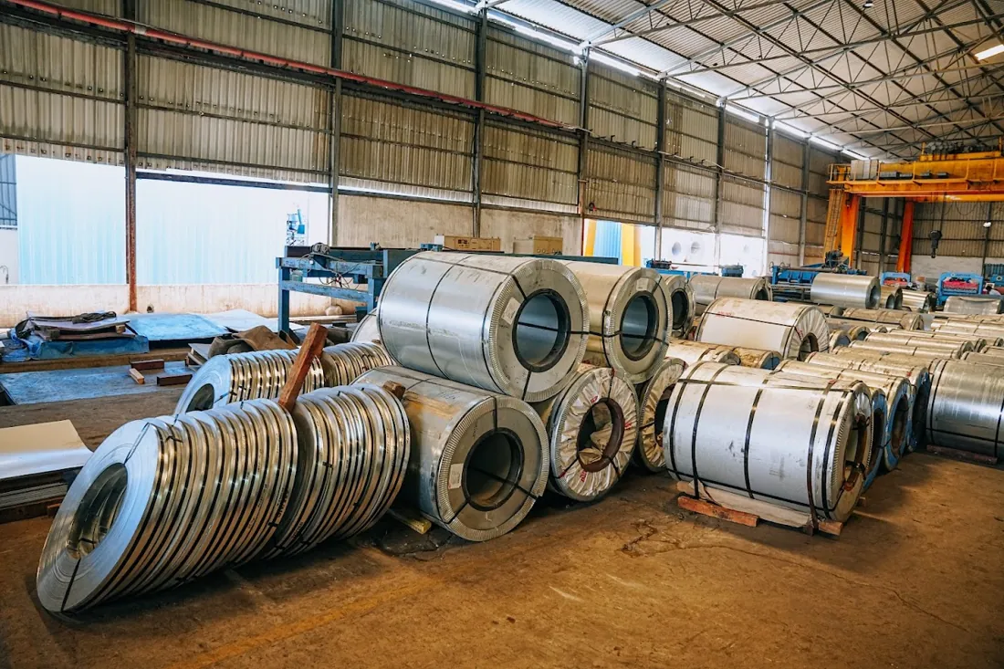 Hot-rolled steel coils stacked at the HST Steels processing facility in Hyderabad